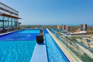 a swimming pool on the roof of a building at GHL Collection Barranquilla Hotel in Barranquilla