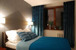 Cama ou camas em um quarto em Good Time Apartments Warsaw City Center