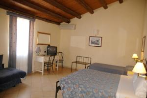 Postel nebo postele na pokoji v ubytování Hotel Relais Modica