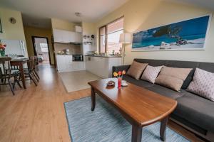 a living room with a couch and a table at Veli Hills Apartments in Velingrad