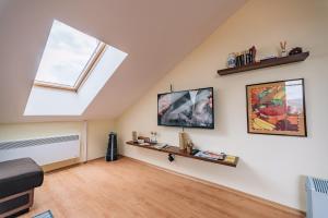 a living room with a skylight and a window at Veli Hills Apartments in Velingrad