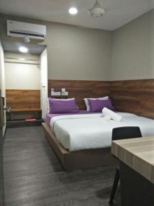 Postel nebo postele na pokoji v ubytování Qing yun resthouse Bandar, Brunei Darussalam