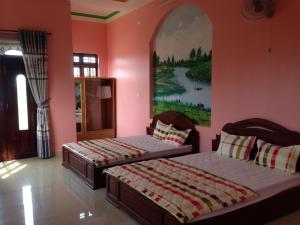 Łóżko lub łóżka w pokoju w obiekcie Hoang Nam Hotel