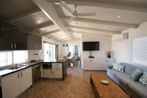 a kitchen and living room with a couch and a table at Ceduna Tourist Park in Ceduna