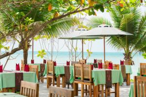 a group of tables and chairs on a beach at Lamai Coconut Beach Resort in Lamai