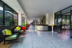 a lobby of a building with chairs and tables at Capital Mansion - SHA Certified in Bangkok