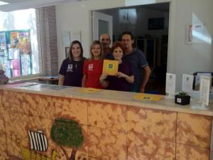 a group of people standing behind a counter at Villaggio Camping Odissea in Marina di Camerota