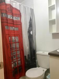 a bathroom with a red telephone booth shower curtain at Cosmopolita Rojo in La Serena +68 photos