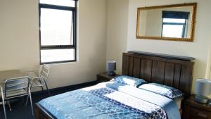 
a bedroom with a bed and a desk at Australia Hotel Fremantle in Fremantle
