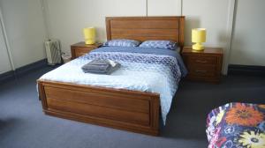 
a bed with two pillows and a night stand at Australia Hotel Fremantle in Fremantle
