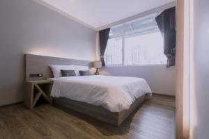 Postel nebo postele na pokoji v ubytování Maxim's Inn