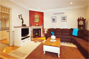 a living room with a couch and a table at Brantwood Cottage Luxury Accommodation in Blackheath