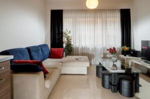 a living room with a couch and a table at The Queen Luxury Apartments - Villa Serena in Luxembourg