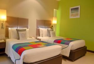 Postel nebo postele na pokoji v ubytování Grand Mercure Vadodara Surya Palace
