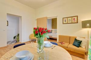 ソポトにあるLion Apartments - Unique 755のリビングルーム(テーブル、赤いバラ付)