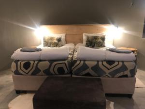 two beds sitting next to each other in a room at A Stone's Throw Accommodation in Grahamstown