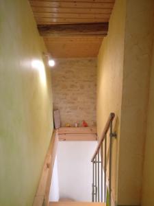 a staircase in a room with a wooden ceiling at Des Km à La Ronde in La Ronde