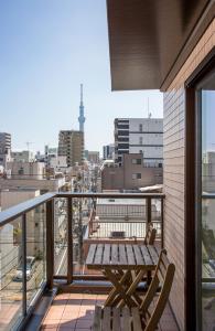 a balcony with a wooden table and bench on a building at Hotel SAILS in Tokyo