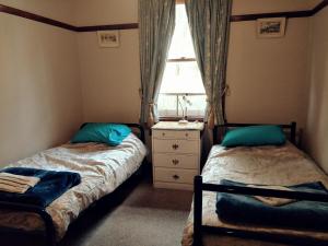 two beds in a small room with a window at Kinross Metcalfe Farm in Metcalfe
