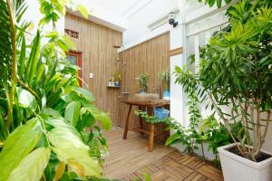 a tropical bathroom with plants and a sink at La Marina Boutique Hotel & Spa in Mui Ne