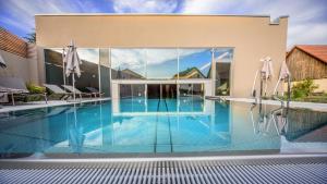 a swimming pool in front of a house at Landhotel Weißes Roß in Illschwang