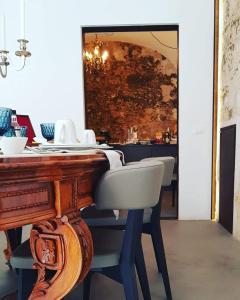a dining room table with chairs and a mirror at Settegrana in Cinisi