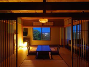 a room with a table and chairs and a window at Ohana in Yanagawa
