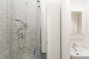 a bathroom with a shower and a sink at Belvedere White Flat in Trieste