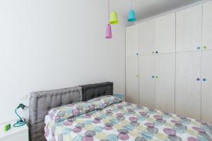 a bedroom with a bed and white cabinets at Belvedere White Flat in Trieste