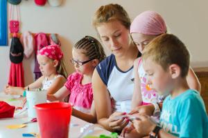 a group of children sitting at a table playing with paint at H10 Suites Lanzarote Gardens in Costa Teguise