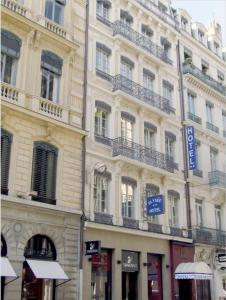 un gran edificio con balcones en un lateral en Hotel Elysée en Lyon