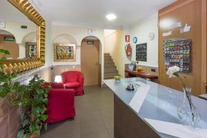 a waiting room of a pharmacy with red chairs at Hostel Malaga Inn in Torremolinos