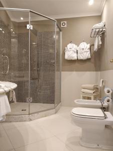 a bathroom with a shower and a toilet and a sink at Hotel Della Piccola Marina in Capri