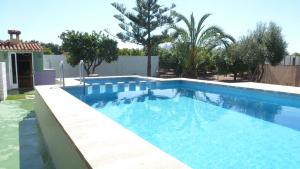 a large swimming pool in a yard with trees at Chalet Verde in Tavernes de Valldigna