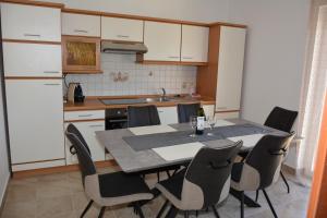 a kitchen with a dining room table and chairs at Taris in Senj