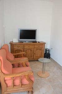 a living room with a tv and a chair and a table at Taris in Senj