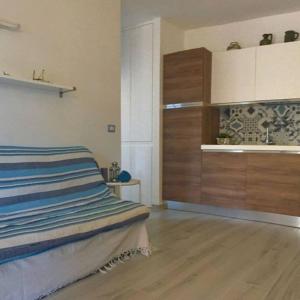 a bedroom with a bed and a wooden cabinet at Un angolo di paradiso a due passi dal mare in Capo Coda Cavallo