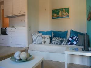 a living room with a couch and a table at Arapakis apartment 2 in Aegina Town