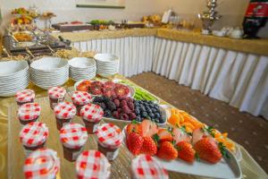 a buffet with strawberries and fruit on a table at Hotel Three Lilies inkl Aquaforum in Františkovy Lázně