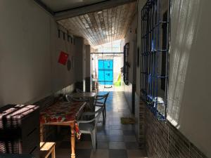 a hallway with a table and chairs and a blue door at Appartement Au Bord De Mer in Boumerdes