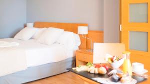 a hotel room with a bed and a tray of food at Hotel Clipper - EL DELFÍN VERDE RESORTS - Platja de Pals in Torroella de Montgrí