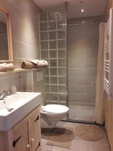 a bathroom with a toilet and a shower and a sink at Domaine Airborne in Angoville-au-Plain +27 photos