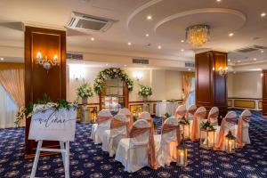 a room with a bunch of chairs in a room at Aquamare Beach Hotel & Spa in Paphos +37 photos