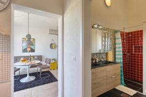 a bathroom with a sink and a table and a shower at Villa Marizella in Premantura +63 photos