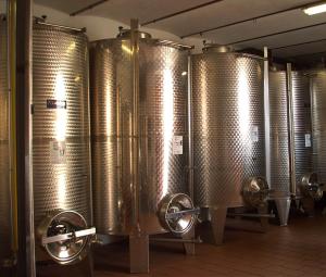 a row of silver wine barrels in a brewery at Agriturismo Finestre di Langa in Trezzo Tinella +30 photos