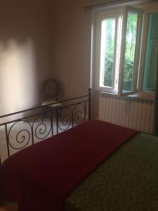 a bedroom with a bed and two windows at Villa Laura in Cinquale