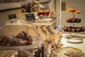 a display of different types of pastries in a bakery at Locanda della Posta Boutique Hotel in Perugia
