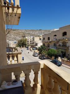 a view of a street from a balcony at Palm Court Apartment in Xlendi