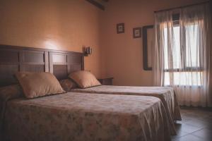 Łóżko lub łóżka w pokoju w obiekcie Casa Rural Monfragüe