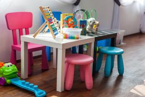 a table with chairs and a table with toys on it at Hotel Horyzont in Rzeszów